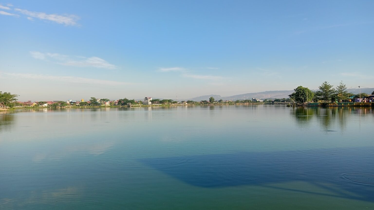 A large body of water surrounded by trees